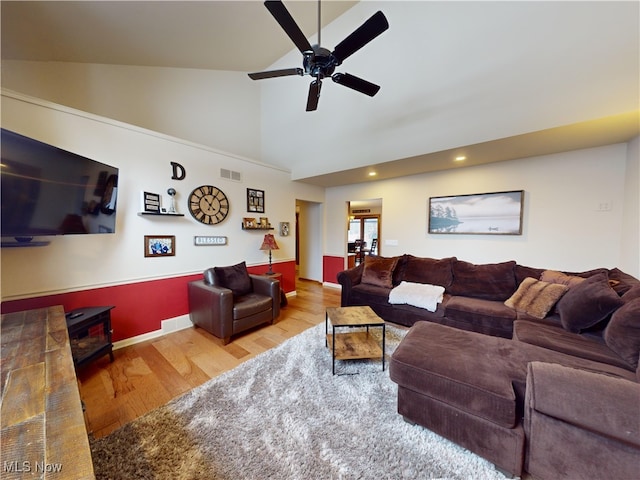 living room with ceiling fan, wood-type flooring, and high vaulted ceiling