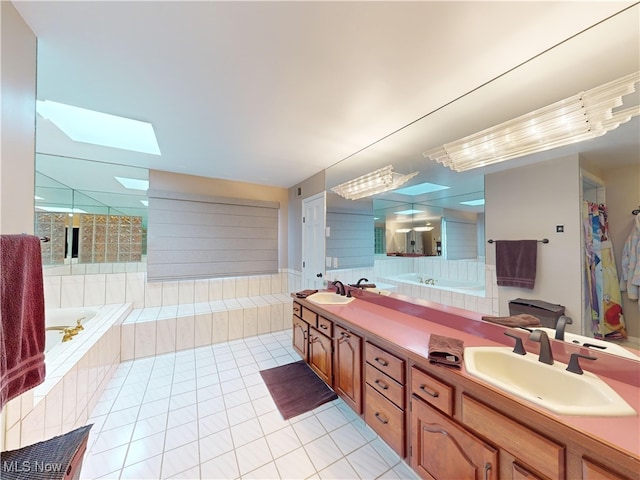 bathroom featuring vanity, a skylight, tile patterned floors, and independent shower and bath