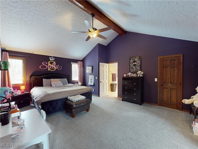 bedroom with a textured ceiling, light colored carpet, ensuite bath, and ceiling fan