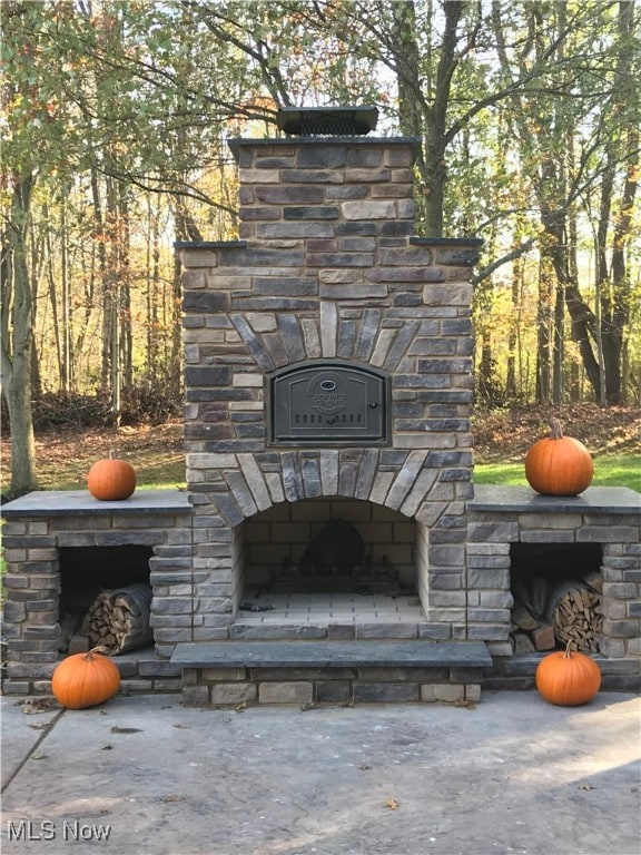 details with an outdoor stone fireplace