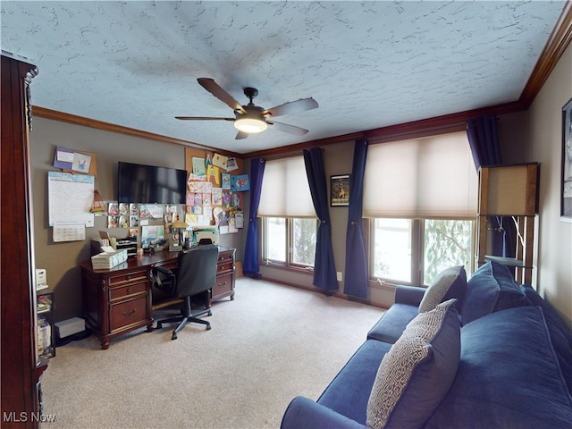 carpeted home office with a textured ceiling, ceiling fan, and ornamental molding