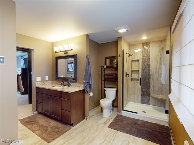 bathroom with vanity, toilet, and walk in shower