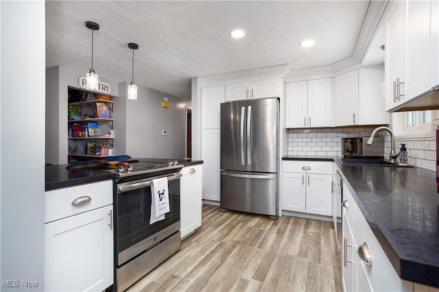 kitchen with backsplash, white cabinetry, sink, and appliances with stainless steel finishes