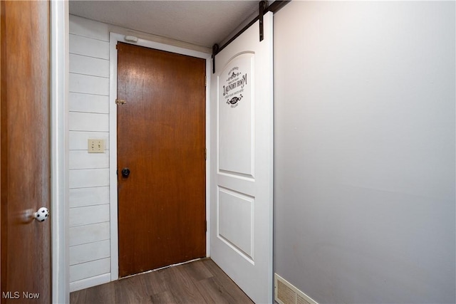 entryway featuring a barn door and dark hardwood / wood-style flooring