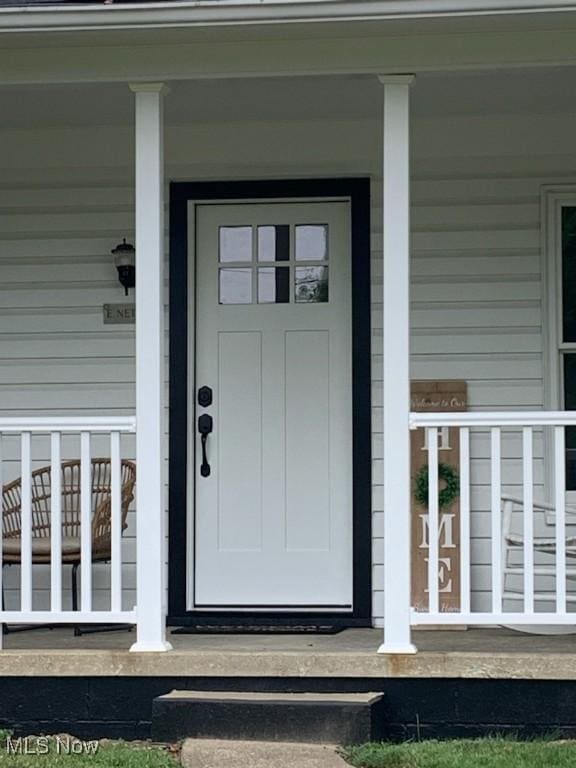 view of exterior entry featuring a porch