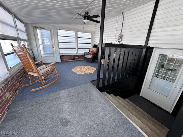 sunroom with ceiling fan and vaulted ceiling