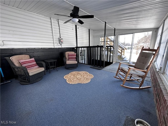 unfurnished sunroom with ceiling fan