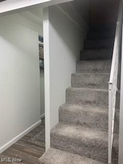 stairs with hardwood / wood-style flooring