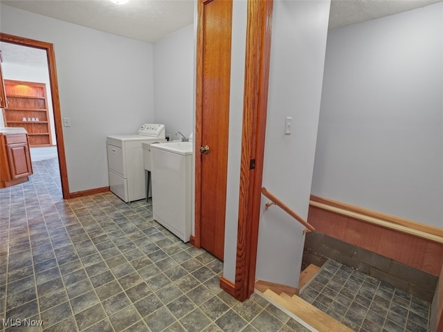 clothes washing area featuring independent washer and dryer and a textured ceiling