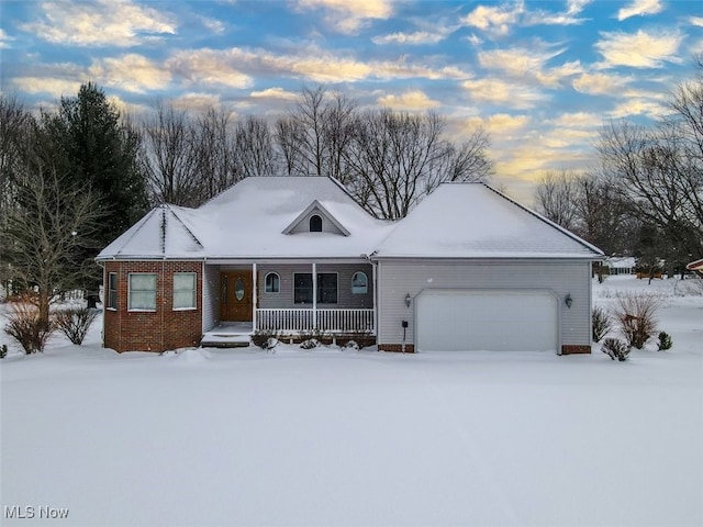 view of front of house featuring covered porch and a garage