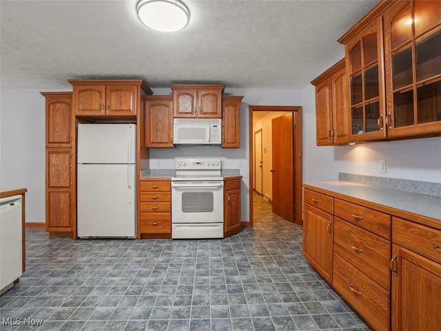 kitchen featuring white appliances and a textured ceiling