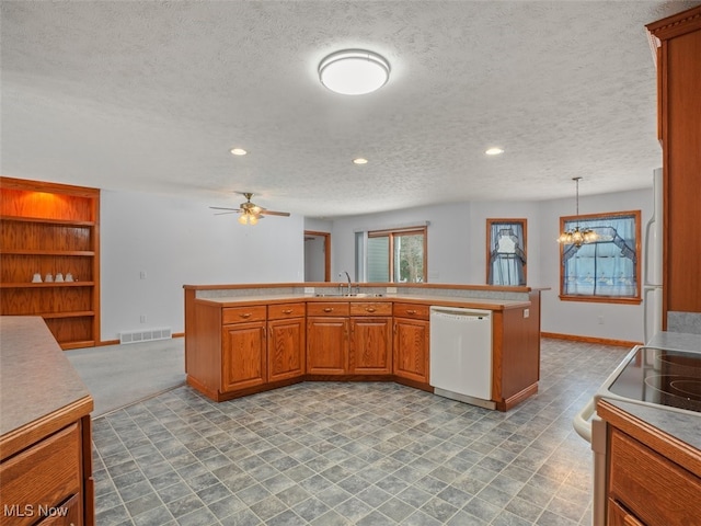 kitchen featuring ceiling fan with notable chandelier, white appliances, a textured ceiling, decorative light fixtures, and sink