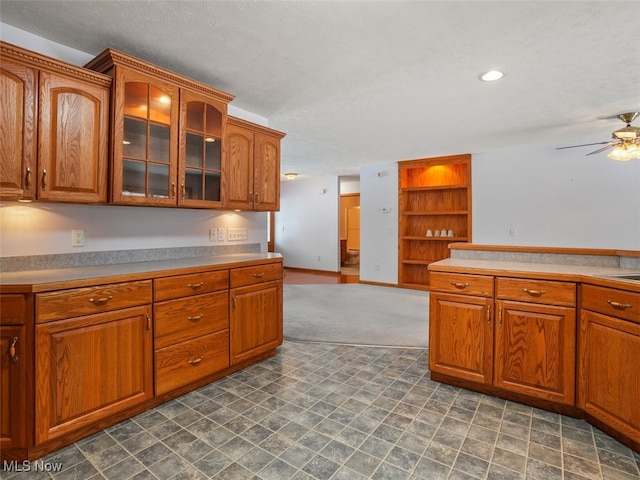 kitchen featuring ceiling fan and a textured ceiling