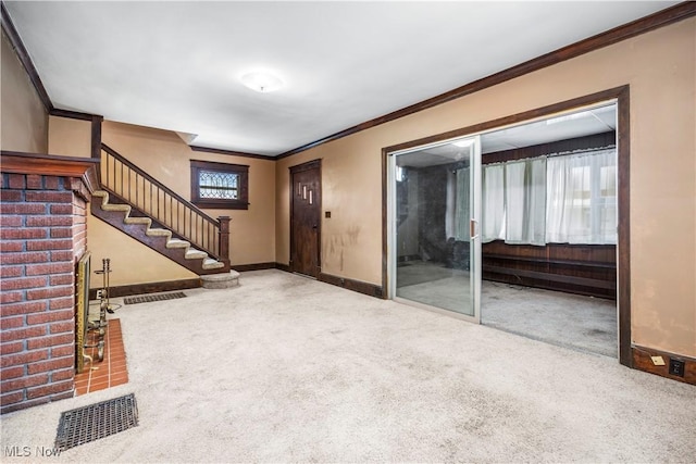 entrance foyer featuring carpet flooring and crown molding