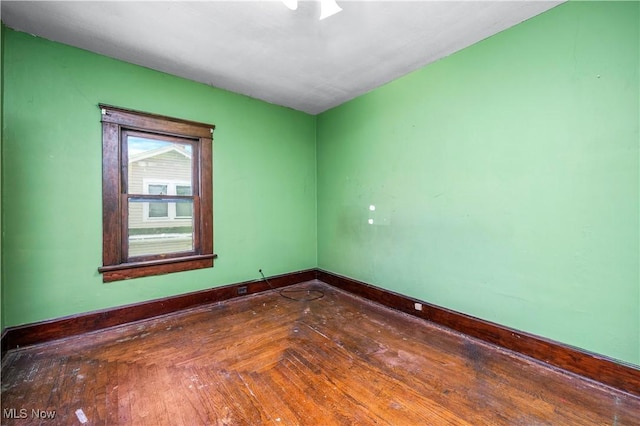 unfurnished room featuring dark parquet flooring