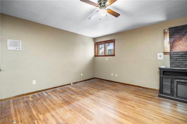 unfurnished living room with ceiling fan and light hardwood / wood-style flooring