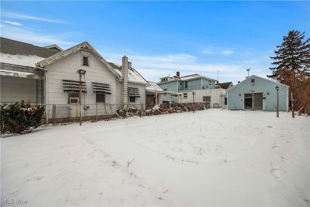 view of snow covered rear of property