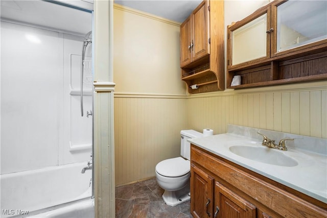 full bathroom featuring vanity, toilet, wooden walls, and bathtub / shower combination