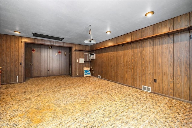 basement featuring carpet and a wall mounted air conditioner