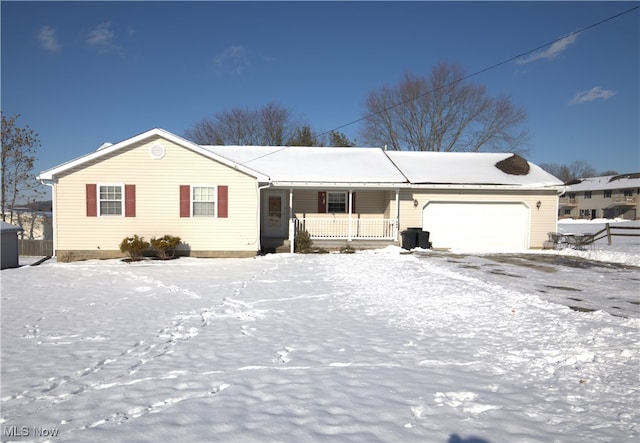 single story home with a porch and a garage