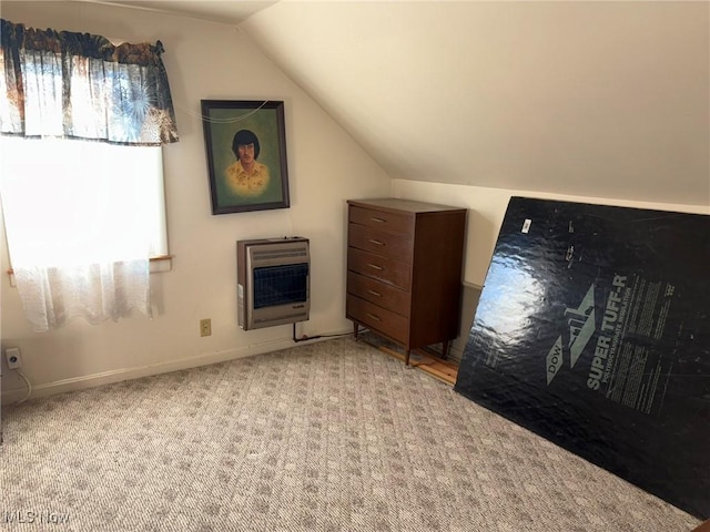 additional living space featuring light carpet, heating unit, and vaulted ceiling