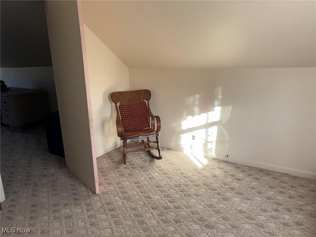 sitting room with light colored carpet and lofted ceiling