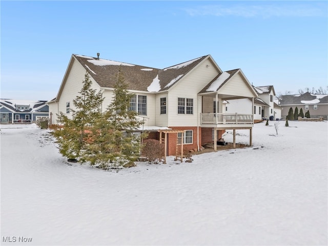 view of snow covered rear of property