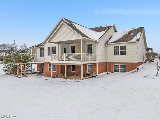 view of snow covered rear of property