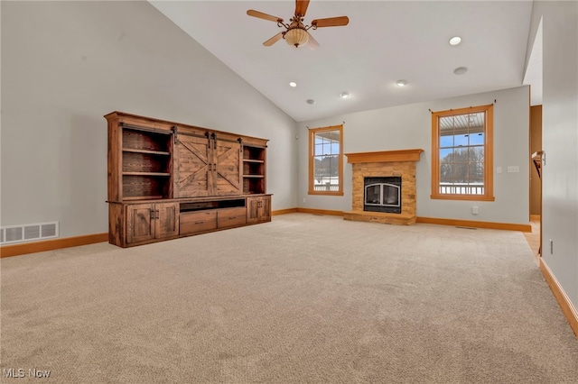 unfurnished living room with ceiling fan, light colored carpet, and high vaulted ceiling