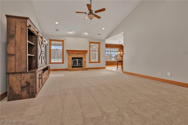 unfurnished living room featuring high vaulted ceiling, light colored carpet, and ceiling fan with notable chandelier