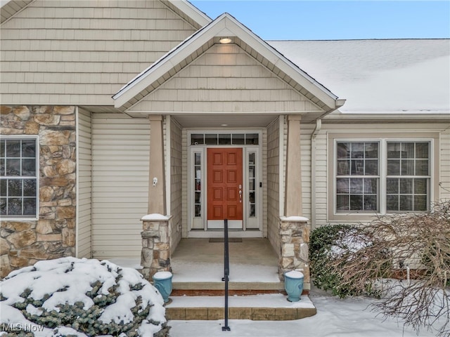 view of snow covered property entrance