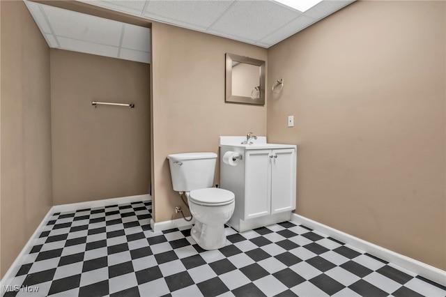 bathroom featuring vanity, a paneled ceiling, and toilet