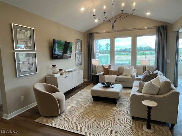 living room featuring hardwood / wood-style floors, lofted ceiling, and an inviting chandelier