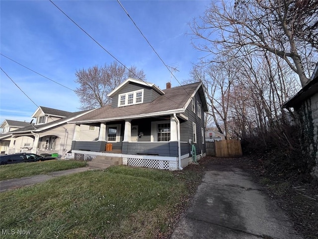 bungalow-style home featuring a porch and a front lawn