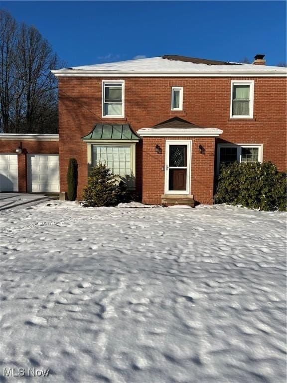 view of front of house featuring brick siding and an attached garage