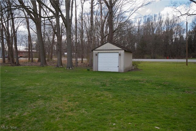 view of yard featuring an outbuilding and a garage