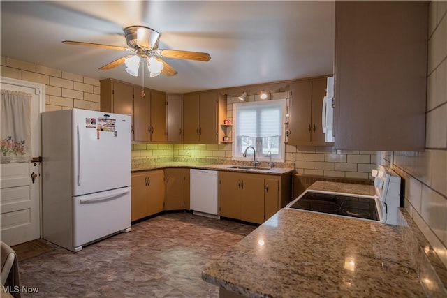 kitchen featuring ceiling fan, white appliances, a sink, and tasteful backsplash