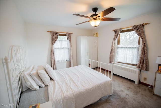 bedroom with radiator, baseboards, carpet floors, and a ceiling fan