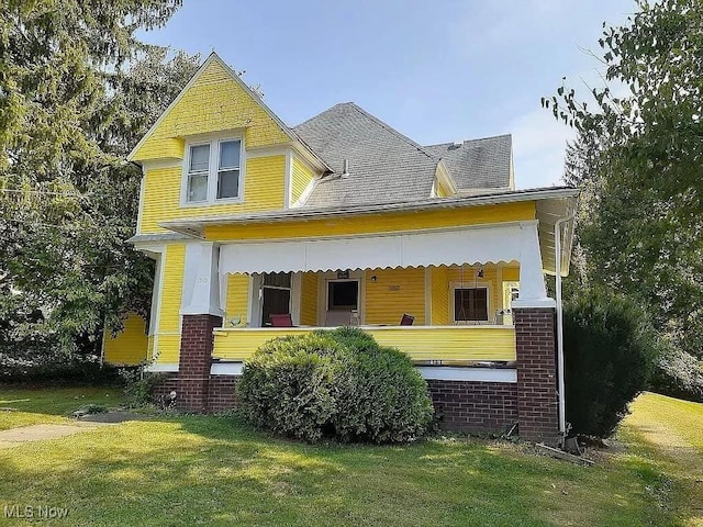 exterior space featuring a yard and covered porch