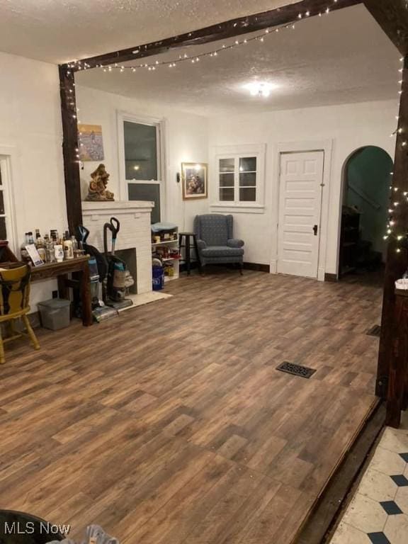 living area with hardwood / wood-style floors and a textured ceiling