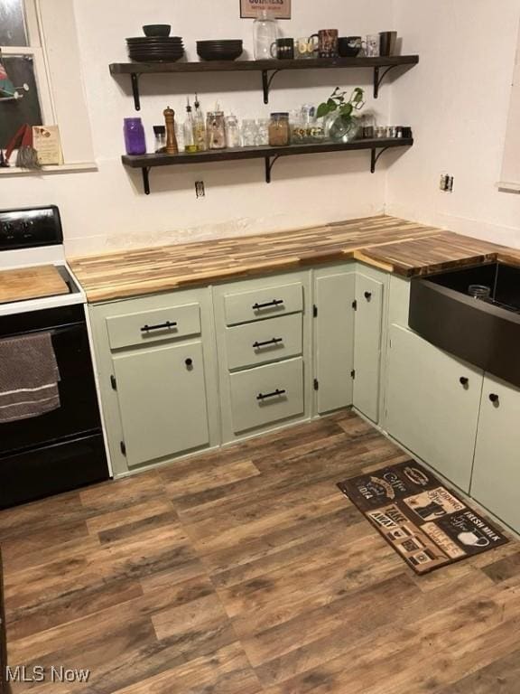 kitchen featuring dark hardwood / wood-style flooring, green cabinetry, and white electric stove