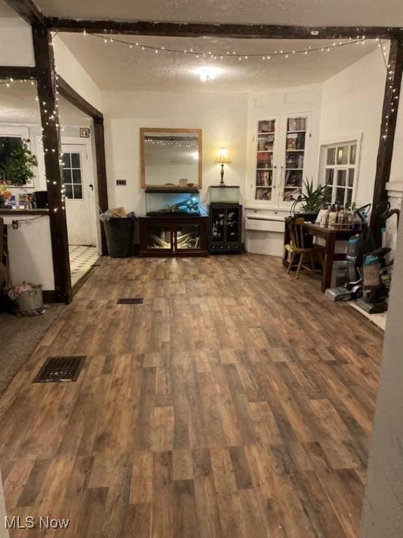 interior space featuring beam ceiling and hardwood / wood-style floors