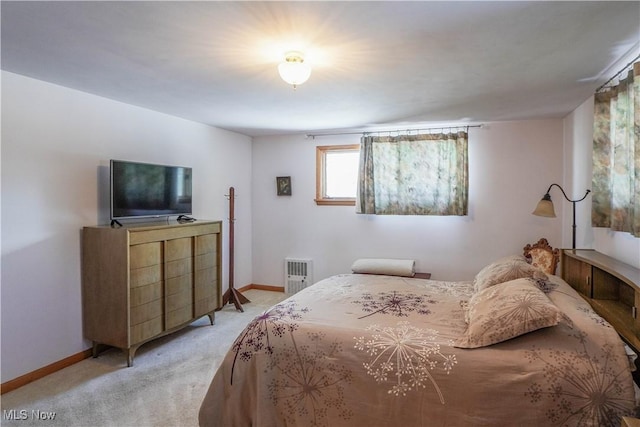 bedroom featuring light colored carpet