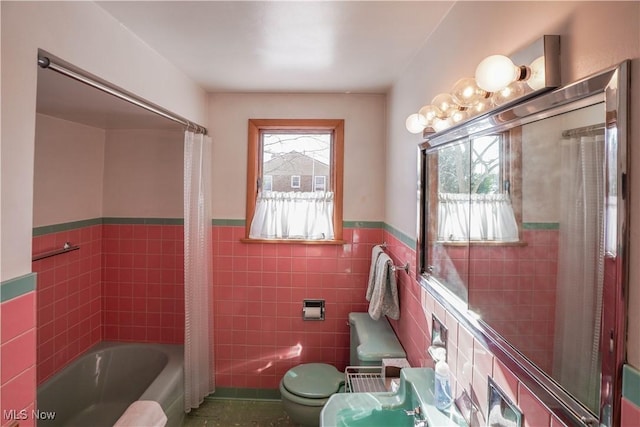 bathroom featuring plenty of natural light, shower / bathtub combination with curtain, tile walls, and toilet