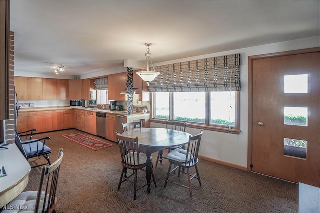 dining room featuring sink and dark carpet