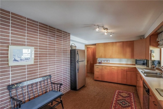 kitchen with carpet flooring, sink, and appliances with stainless steel finishes