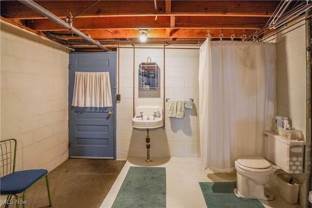 interior space featuring concrete floors and toilet