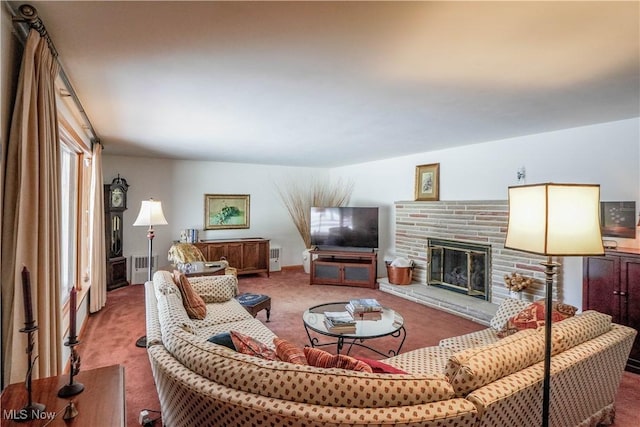 carpeted living room featuring a stone fireplace