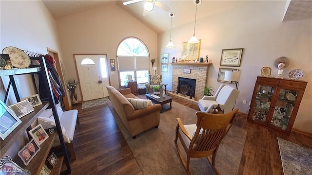 living room featuring ceiling fan, dark hardwood / wood-style flooring, high vaulted ceiling, and a brick fireplace