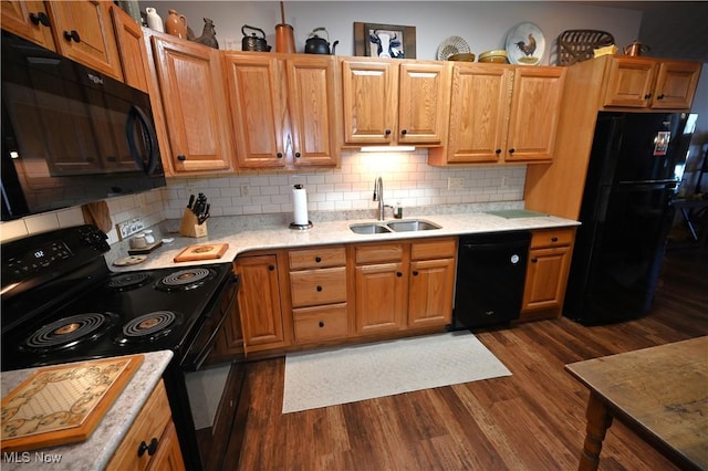 kitchen featuring decorative backsplash, dark hardwood / wood-style flooring, sink, and black appliances